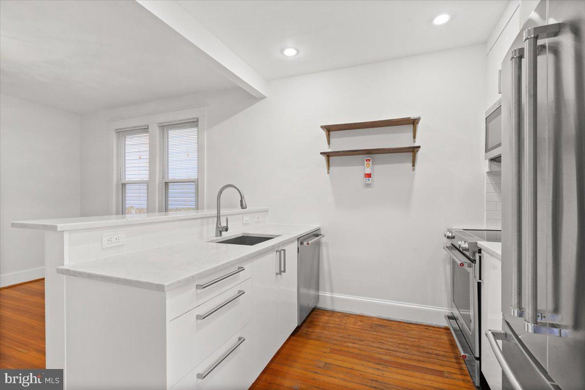 4302 30th Street Mount Rainier, MD 20712 - Photo 4 of 23 a kitchen with a sink and a refrigerator