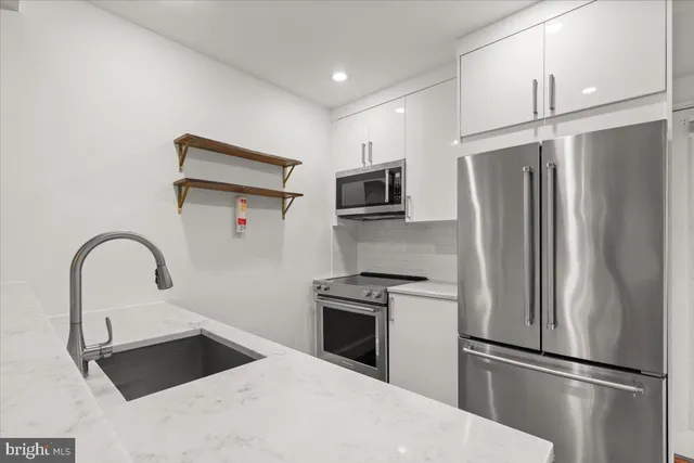 a kitchen with a refrigerator sink and microwave