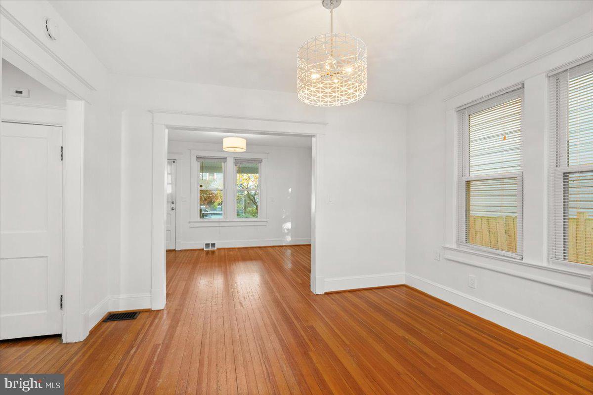 4302 30th Street Mount Rainier, MD 20712 - Photo 6 of 23 an empty room with wooden floor and windows