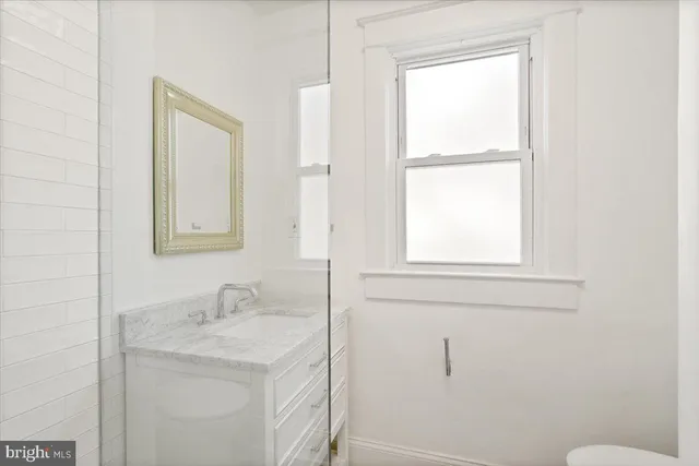 a bathroom with a sink toilet and vanity