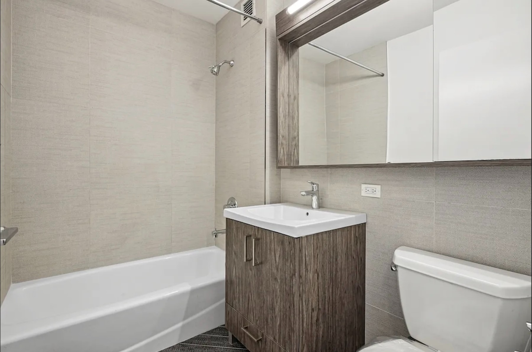 345 East 94th Street, Unit 6B Manhattan, NY 10128 - Photo 3 of 18 a bathroom with a sink a toilet and bathtub