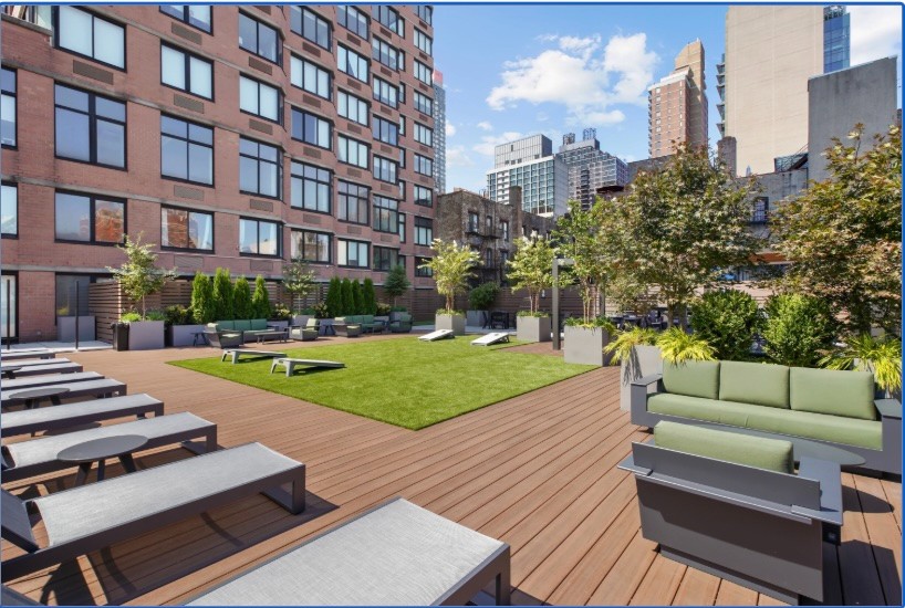 345 East 94th Street, Unit 6B Manhattan, NY 10128 - Photo 5 of 18 a view of a patio with couches and a table and chairs with wooden floor and a yard