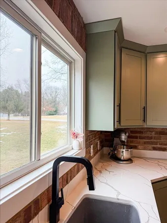 a kitchen with a stove and a wooden floor