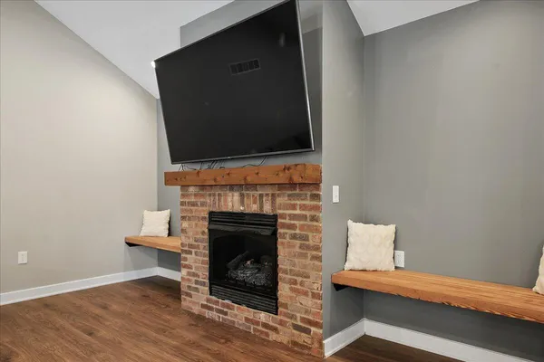 a view of a room with wooden floor and windows