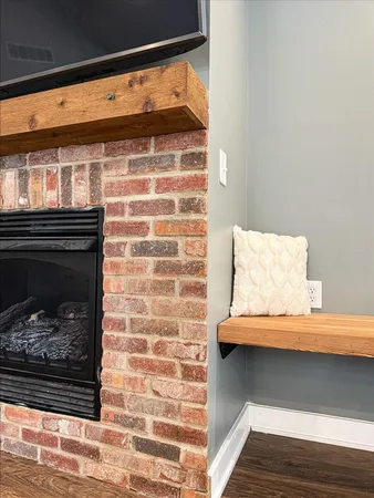 a living room with furniture kitchen view and a chandelier