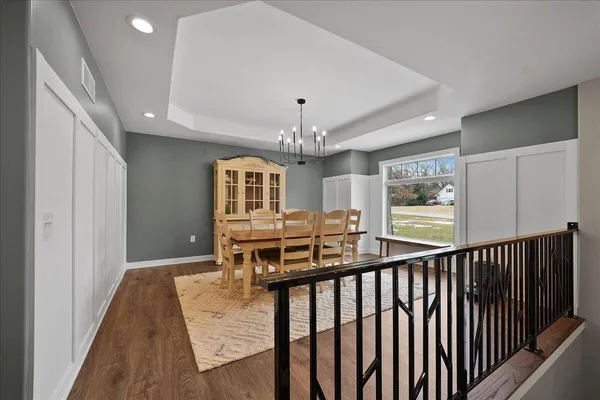 a bedroom with a large bed and a chandelier