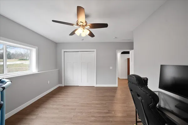 a view of a hardwood floor and staircase