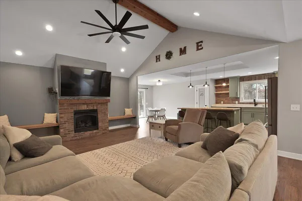 a living room with furniture a fireplace and a flat screen tv