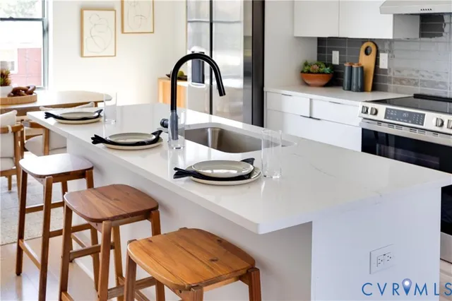 a kitchen with a table chairs and a stove