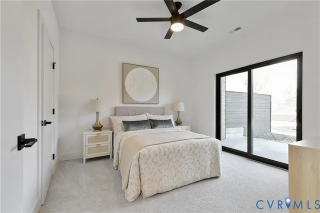 a bedroom with a large bed and a chandelier