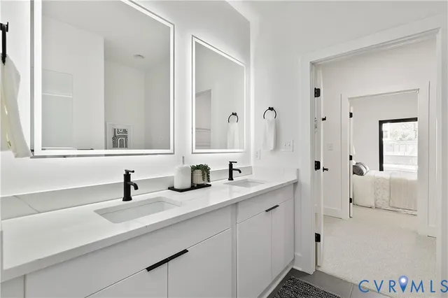 a bathroom with double sink and a mirror