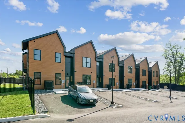 a view of a brick house with large windows