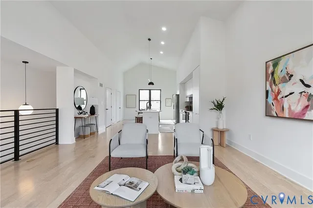 a living room with furniture and wooden floor