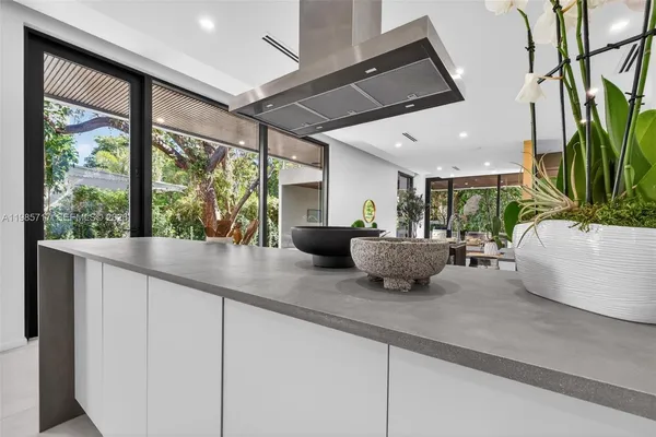 a kitchen with stainless steel appliances granite countertop a stove a sink and a refrigerator