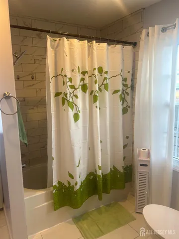 a bathroom with a shower and a toilet