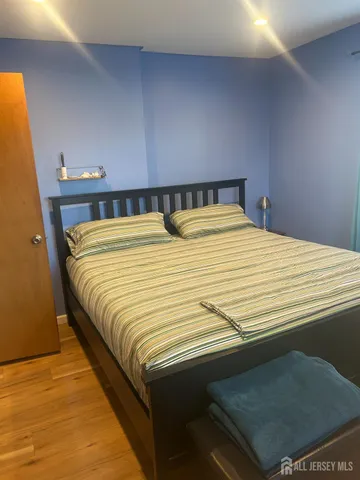 a bedroom with a bed and a night stand