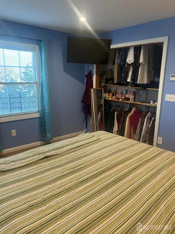 a bed room with a bed and a television