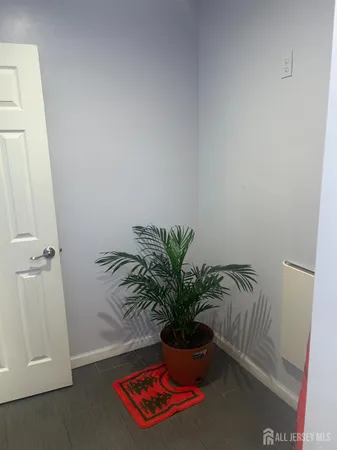a potted plant sitting on a floor in a bathroom