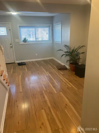 a view of a room with wooden floor and potted plant
