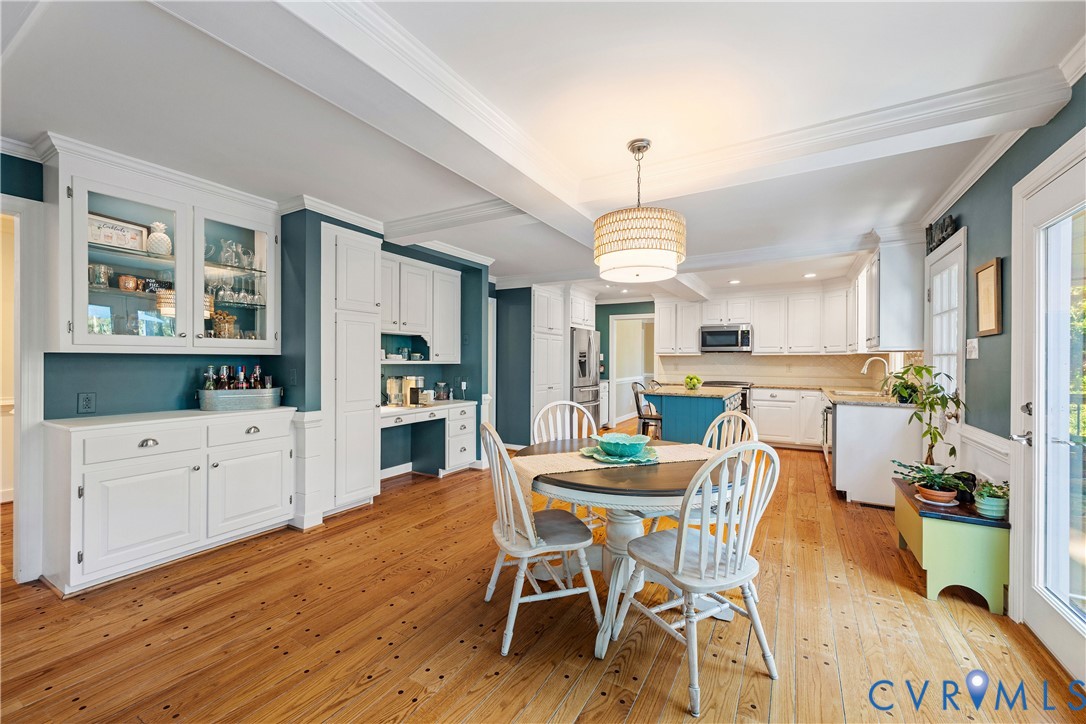 1911 Oakengate Lane Midlothian, VA 23113 - Photo 12 of 47 a dining room with wooden floor a chandelier a wooden table and chairs