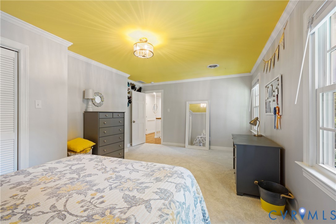 1911 Oakengate Lane Midlothian, VA 23113 - Photo 30 of 47 a bedroom with a bed and a chandelier