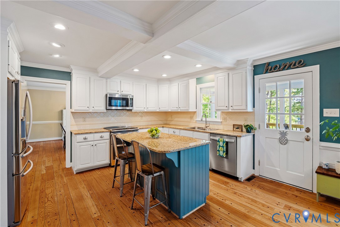 1911 Oakengate Lane Midlothian, VA 23113 - Photo 8 of 47 a kitchen with a stove a sink a refrigerator and cabinets