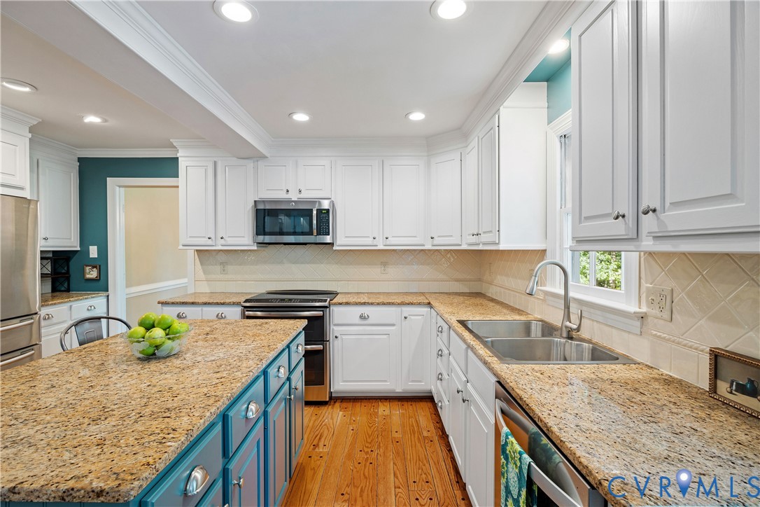 1911 Oakengate Lane Midlothian, VA 23113 - Photo 10 of 47 a kitchen with granite countertop stainless steel appliances and white cabinets