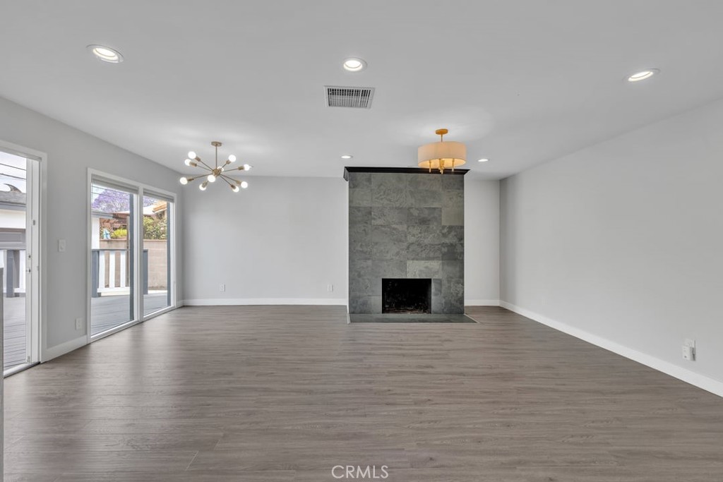 2909 Nipomo Avenue Long Beach, CA 90815 - Photo 12 of 41 a view of an empty room with wooden floor and a fireplace