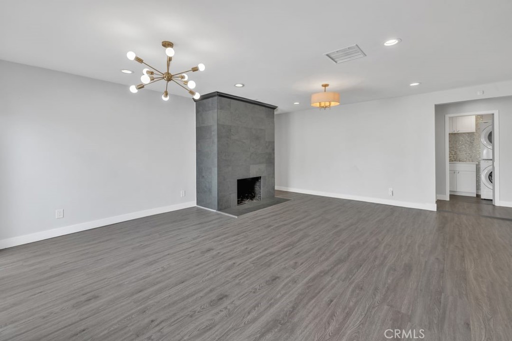 2909 Nipomo Avenue Long Beach, CA 90815 - Photo 14 of 41 a view of an empty room with wooden floor and a ceiling fan