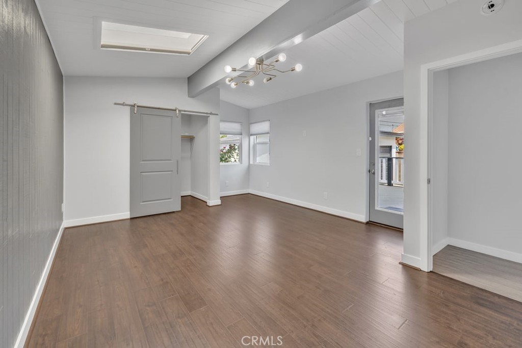 2909 Nipomo Avenue Long Beach, CA 90815 - Photo 15 of 41 an empty room with wooden floor and windows