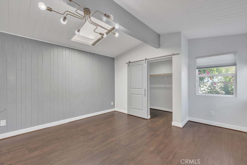 2909 Nipomo Avenue Long Beach, CA 90815 - Photo 18 of 41 an empty room with wooden floor chandelier fan and windows