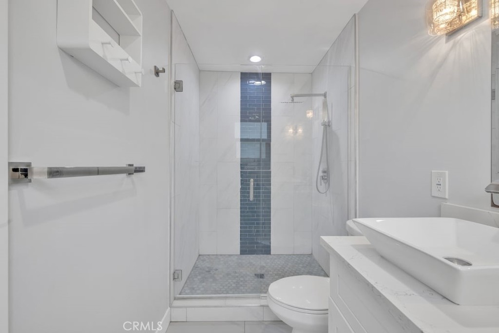 2909 Nipomo Avenue Long Beach, CA 90815 - Photo 20 of 41 a white toilet sitting next to a bathroom sink