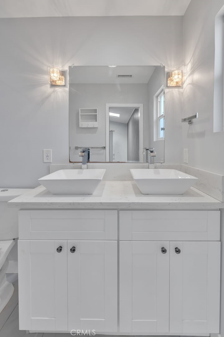 2909 Nipomo Avenue Long Beach, CA 90815 - Photo 21 of 41 a bathroom with double vanity sink and a mirror