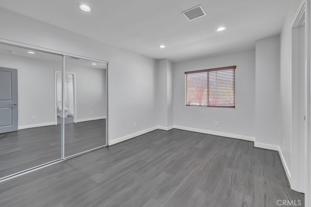 2909 Nipomo Avenue Long Beach, CA 90815 - Photo 24 of 41 an empty room with wooden floor and windows