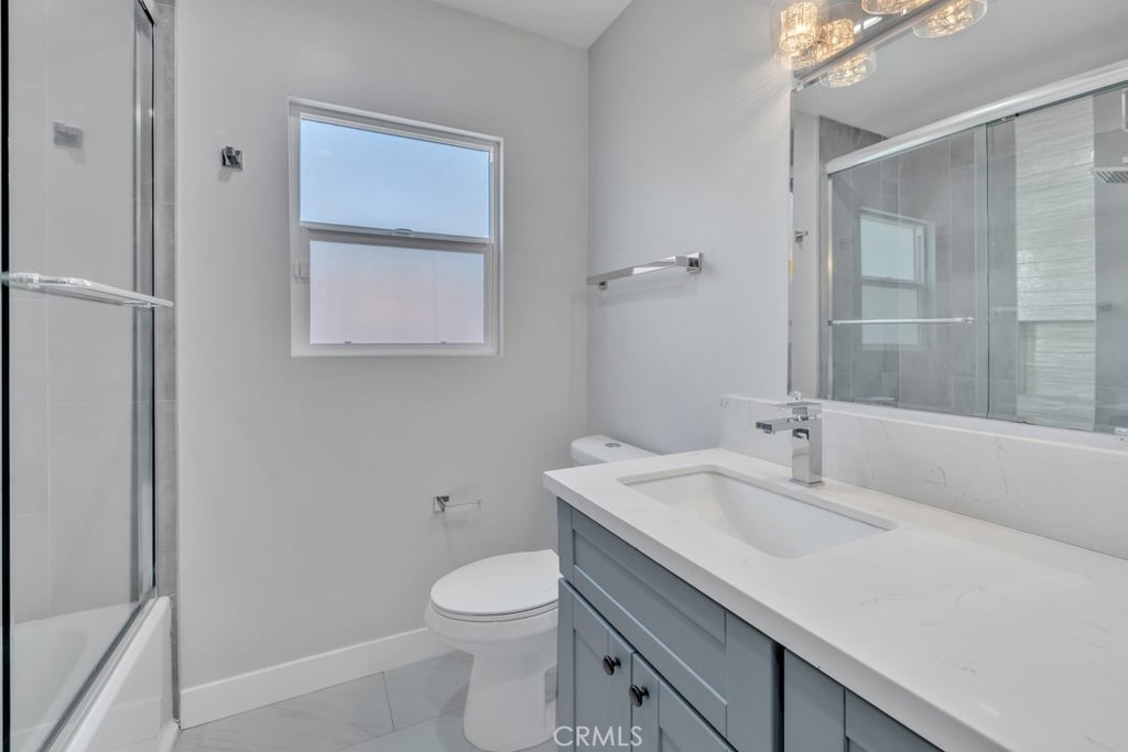 2909 Nipomo Avenue Long Beach, CA 90815 - Photo 29 of 41 a bathroom with a sink a toilet and shower