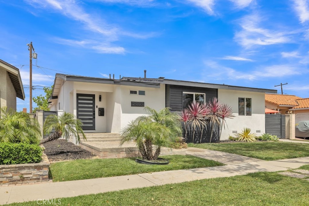 2909 Nipomo Avenue Long Beach, CA 90815 - Photo 3 of 41 a front view of a house with garden