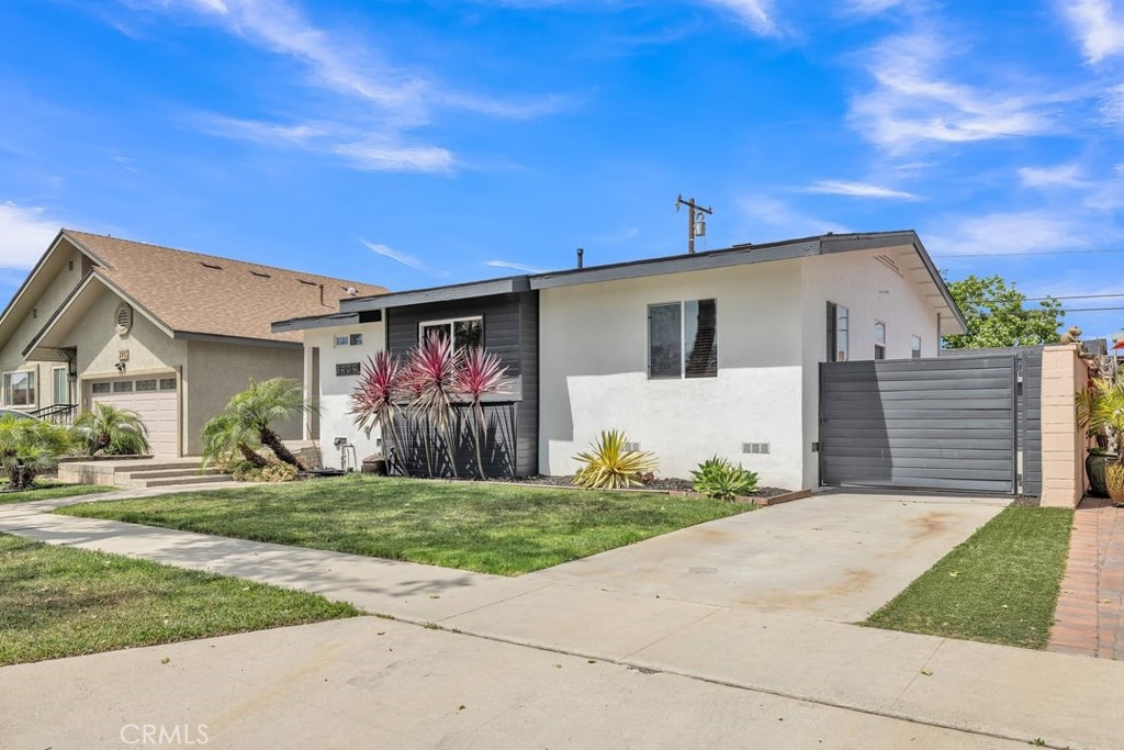 2909 Nipomo Avenue Long Beach, CA 90815 - Photo 5 of 41 a front view of house with yard and trees in the background