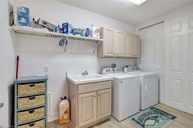 a view of cabinets a sink and a stove in a kitchen
