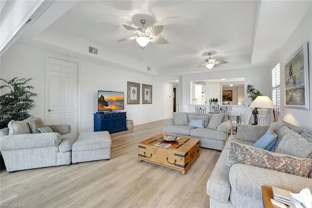 a living room with furniture or couch and a chandelier
