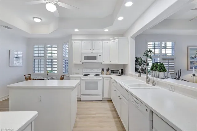 a kitchen with a sink stove cabinets and utility