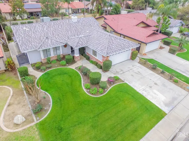 an aerial view of a swimming pool with a garden and plants