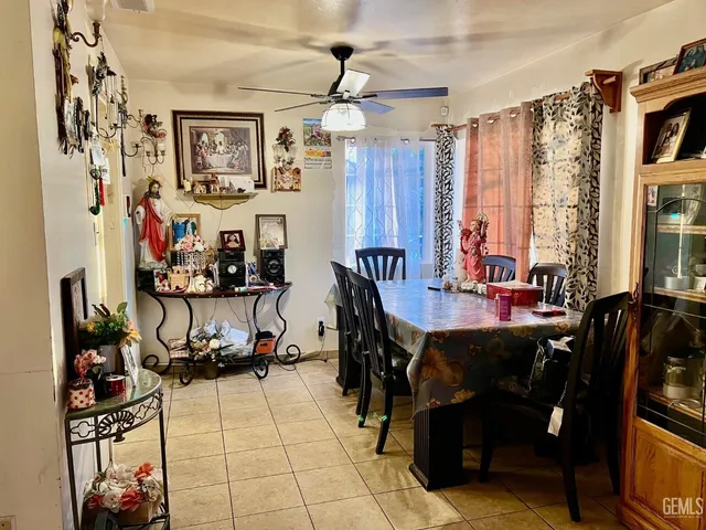 a view of a dining room with furniture and a chandelier