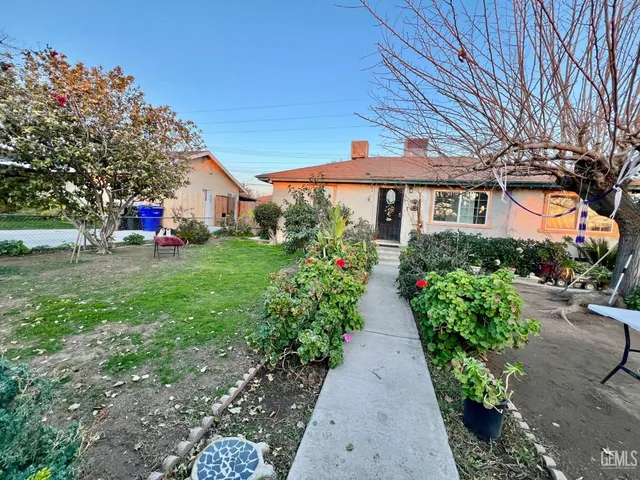 a view of a house with a backyard and a patio