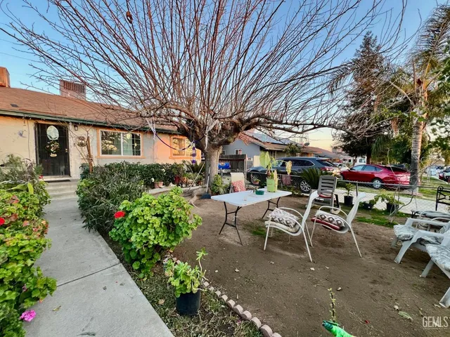 a view of a patio with table and chairs and potted plants