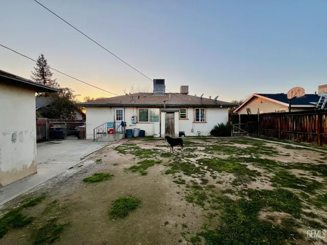 a front view of a house with a yard patio and dining area