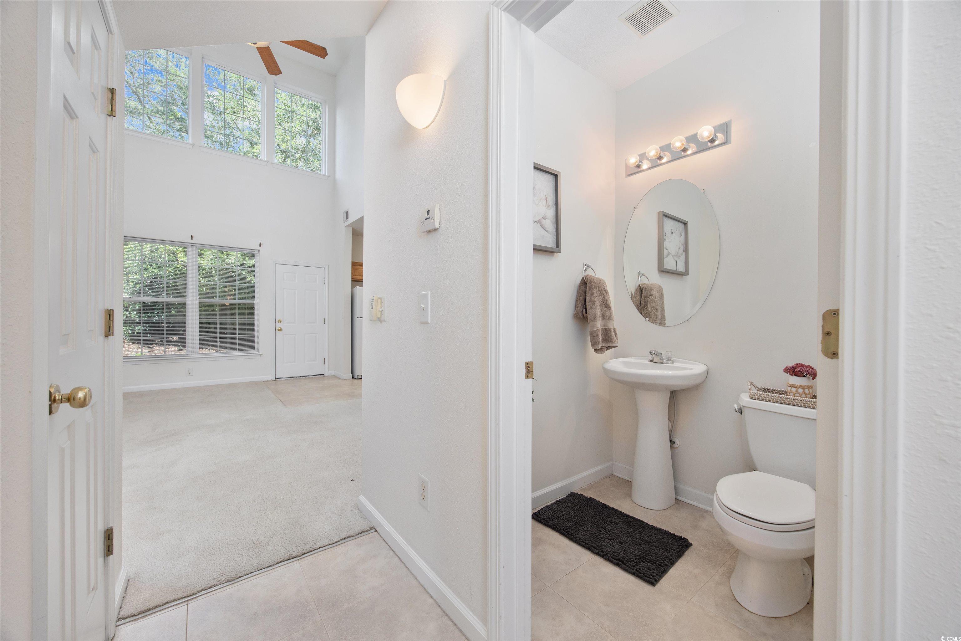 155 Chenoa Drive, Unit D Murrells Inlet, SC 29576 - Photo 12 of 33 Bathroom featuring ceiling fan, tile patterned floors, and a towering ceiling