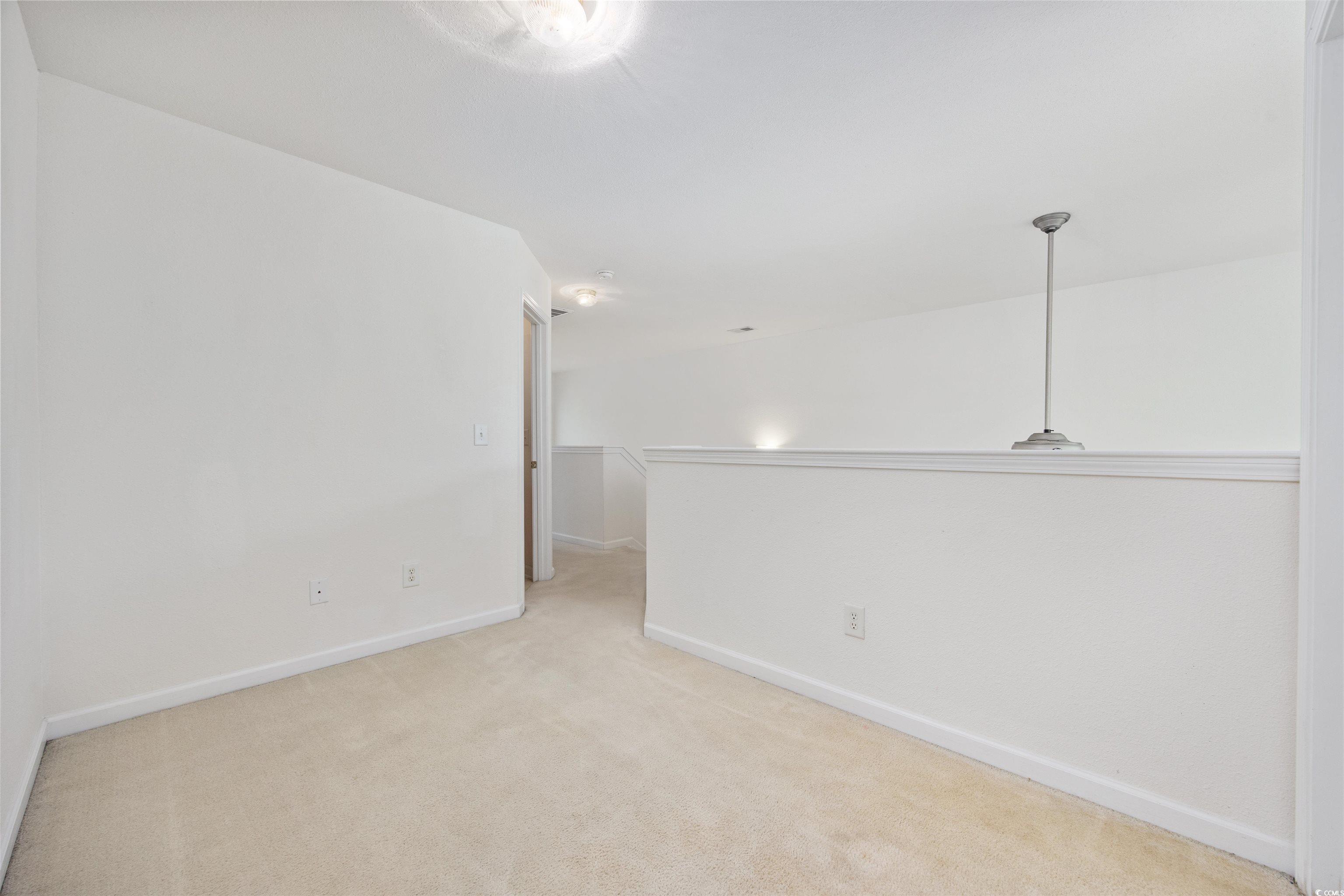155 Chenoa Drive, Unit D Murrells Inlet, SC 29576 - Photo 20 of 33 Carpeted spare room featuring baseboards