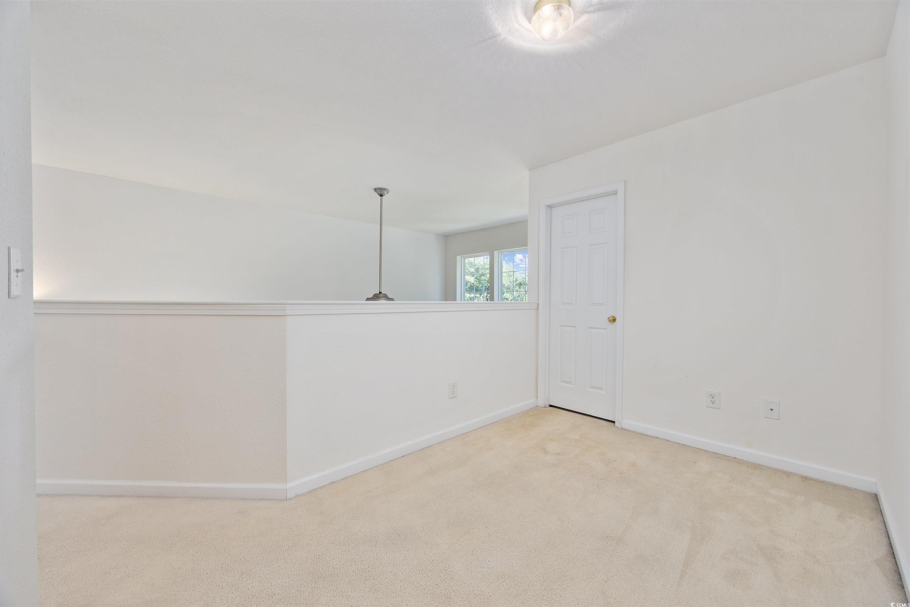 155 Chenoa Drive, Unit D Murrells Inlet, SC 29576 - Photo 21 of 33 Unfurnished room featuring light colored carpet and baseboards