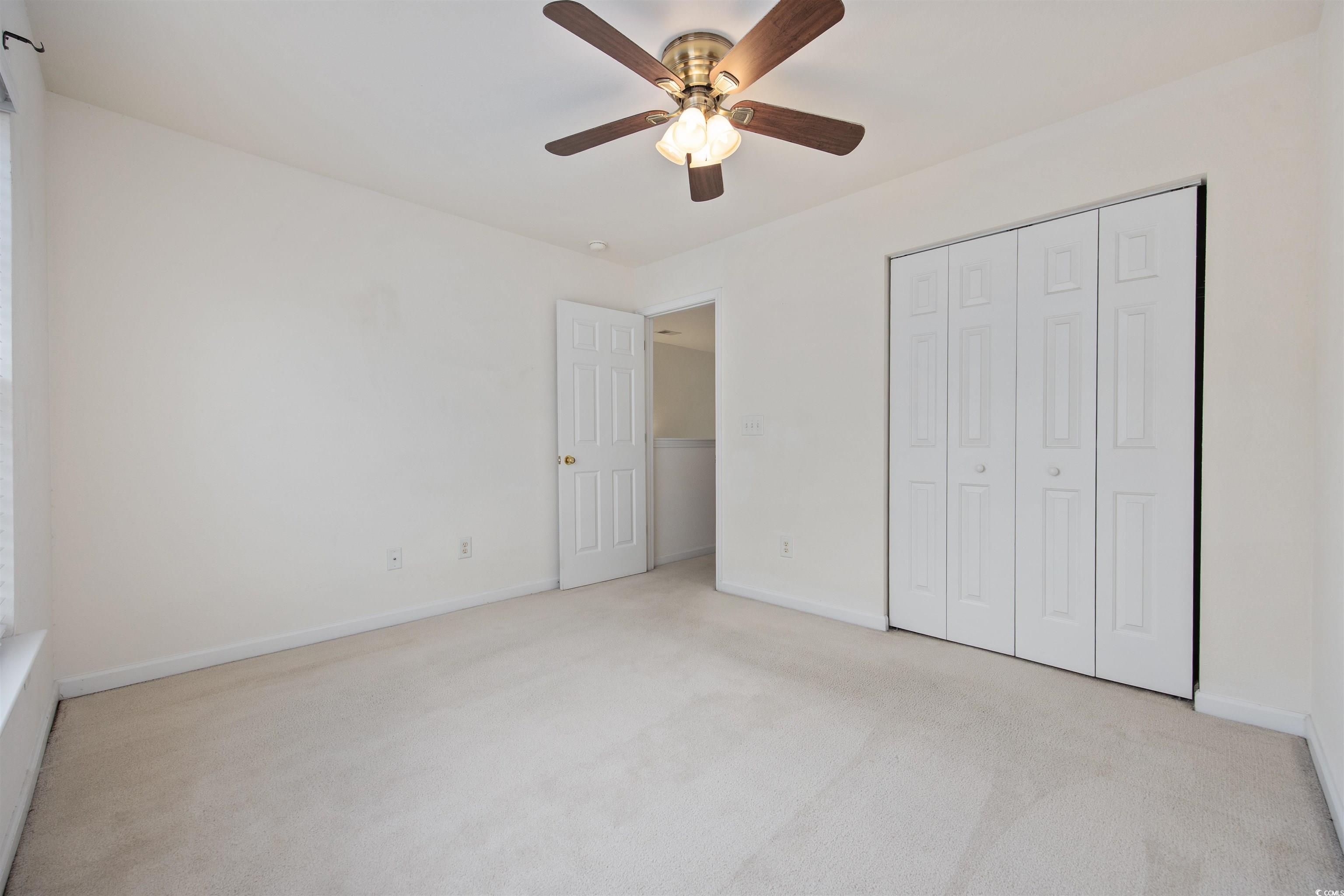 155 Chenoa Drive, Unit D Murrells Inlet, SC 29576 - Photo 22 of 33 Carpeted empty room with baseboards