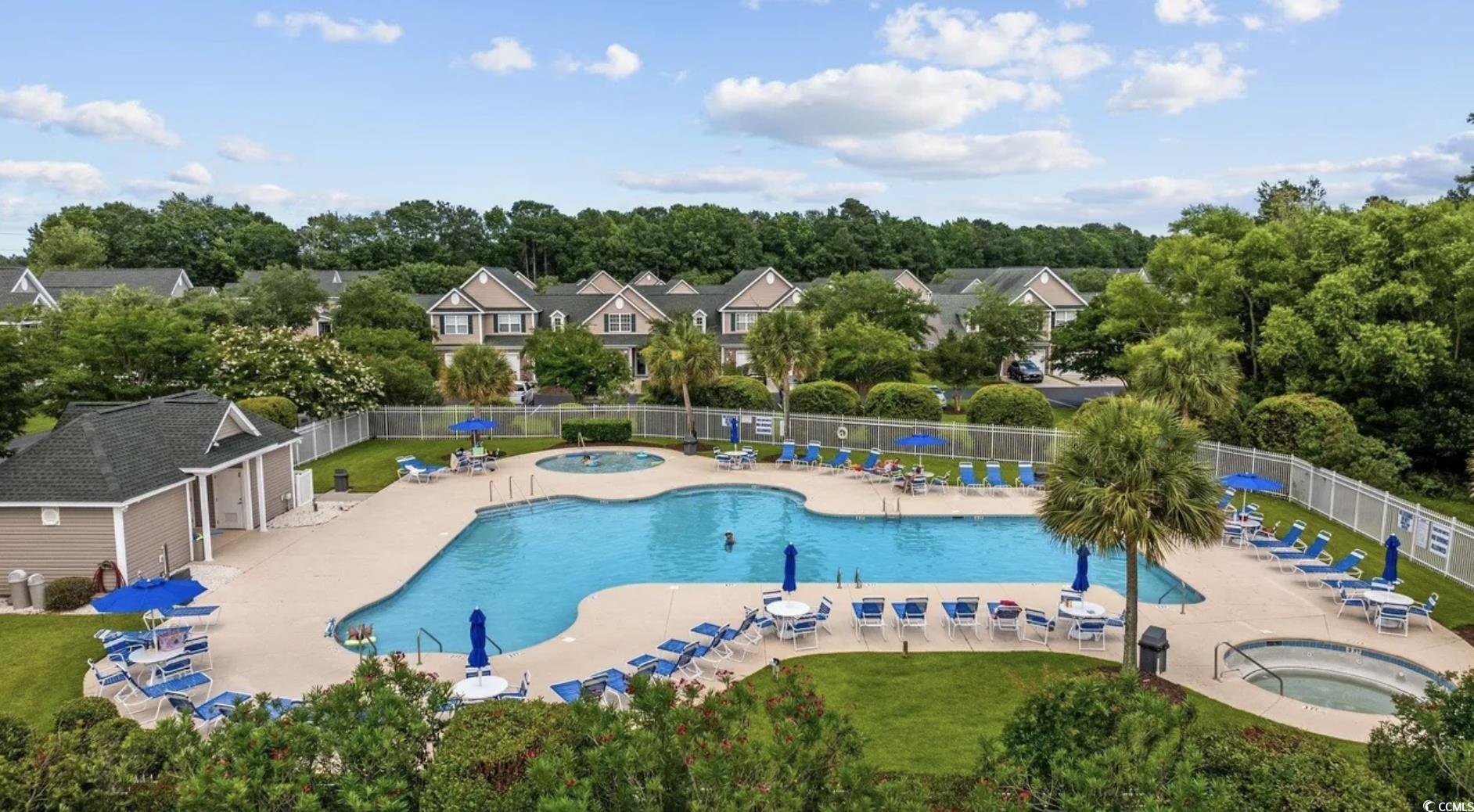 155 Chenoa Drive, Unit D Murrells Inlet, SC 29576 - Photo 3 of 33 Community pool featuring a community hot tub and a patio